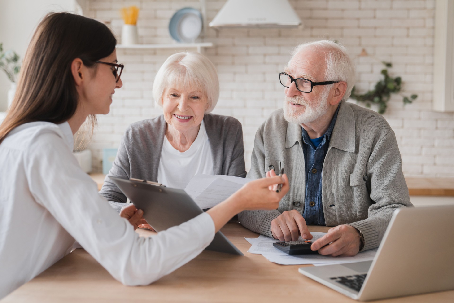 Successful deal. Lawyer financial adviser helping consulting showing contract mortgage loan credit business startup, signing documents by elderly senior old grandparents couple at home
